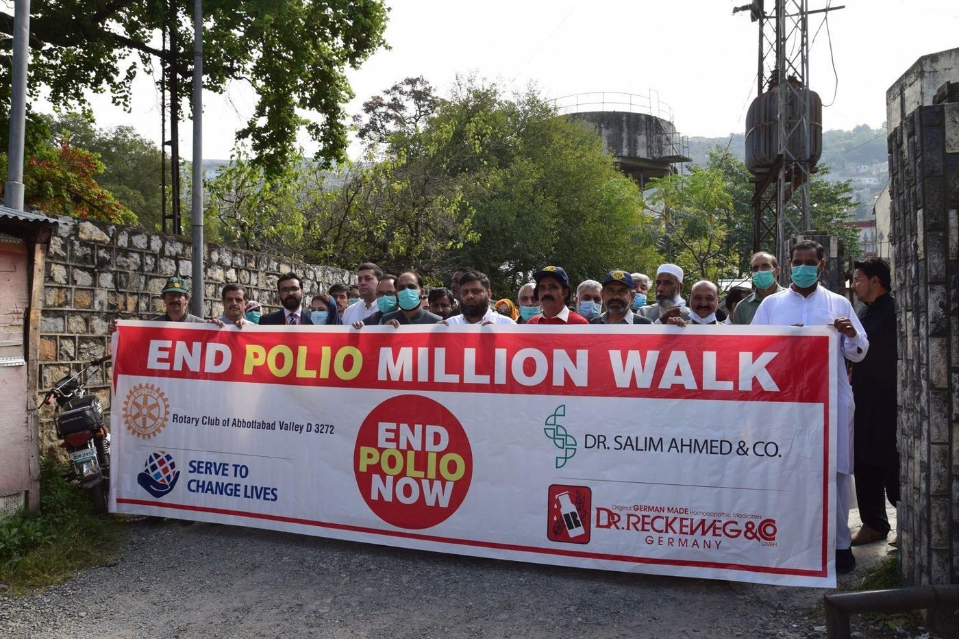 Rotarians holding an End Polio Million Walk banner outside the District Health Office, Abbottabad