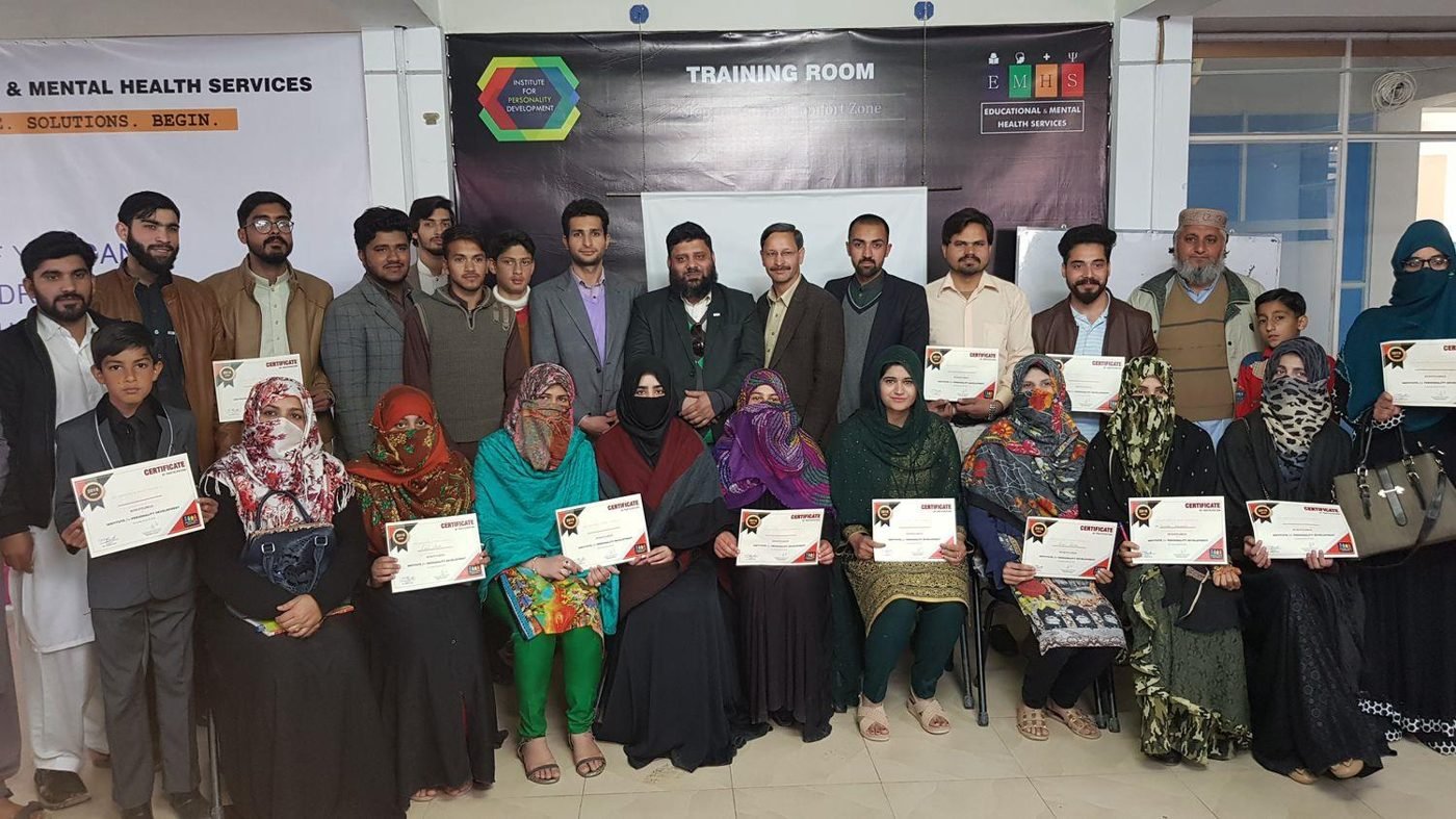 Participants holding certificates after a free personality-development seminar