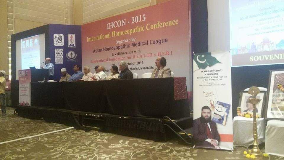 Stage of IHCON 2015 in Mumbai with a book launch banner for Rite Healing and Mindfulness by Dr. Ahmed Ejaz