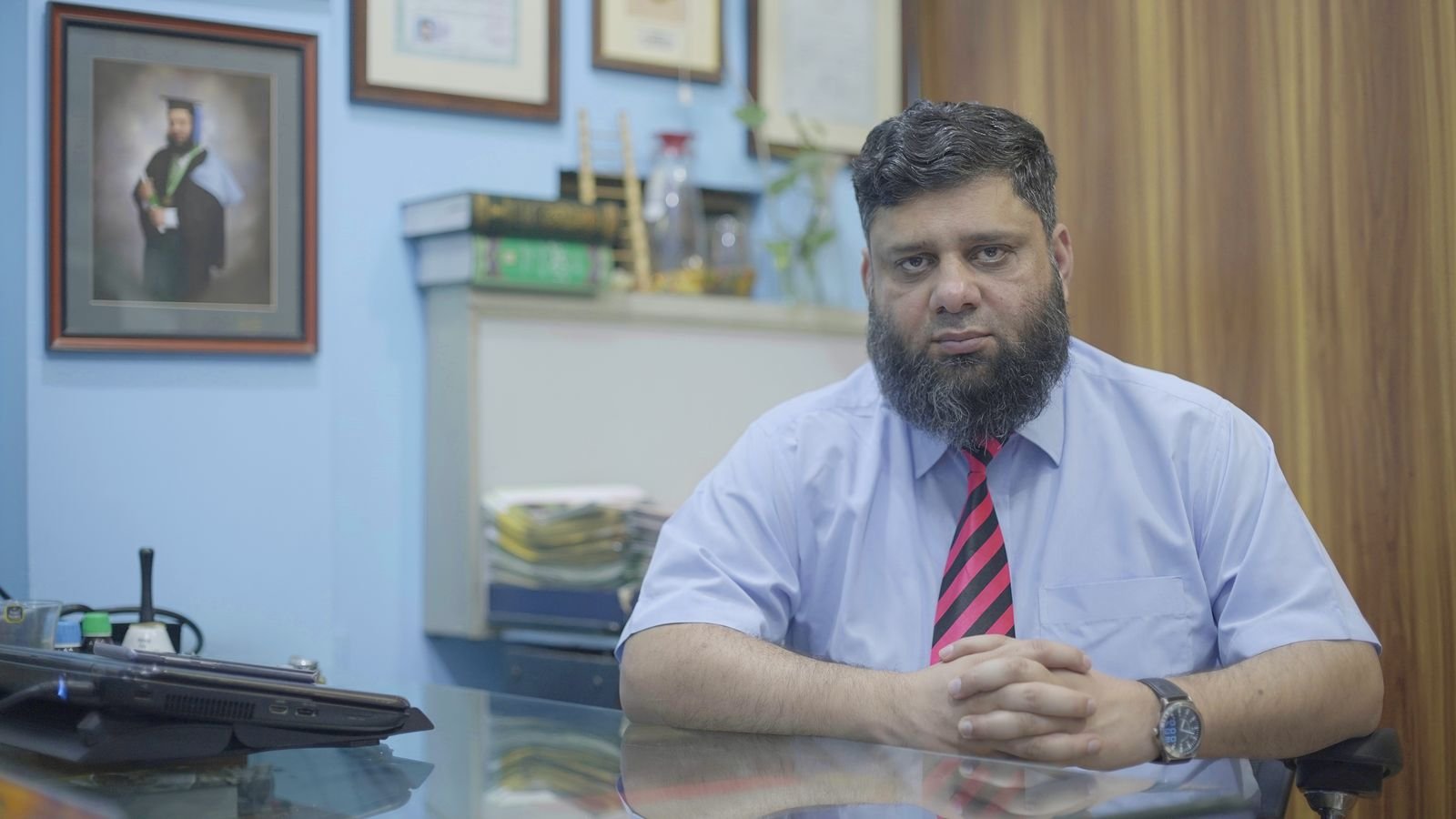 Dr. Ahmed Ejaz seated at his office desk
