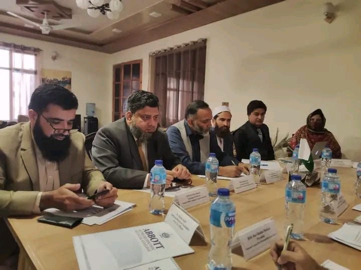 Dr. Ahmed Ejaz at a meeting table with community stakeholders